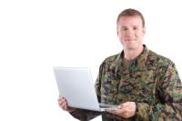 Military man holding a computer