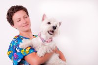 Vet assistant with cute dog in her arms