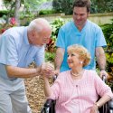 Caregiver with older couple out in nature