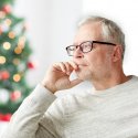 Man sitting in front of Christmas tree