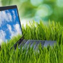 Laptop in a field of green grass