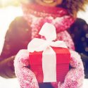 Smiling woman holding wrapped gift