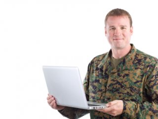 Military man holding a computer