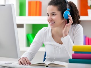 Student at desk with headphones on