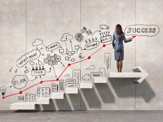Woman on staircase leading up to success