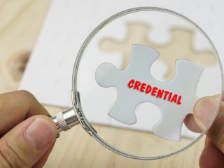 Puzzle piece with the word "credential" on it