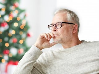 Man sitting in front of Christmas tree