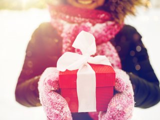 Smiling woman holding wrapped gift