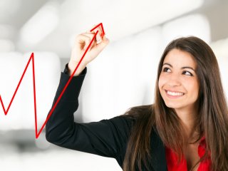 A young businesswoman showing growth on a chart