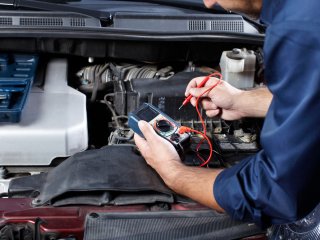 Automotive technician diagnosing engine trouble
